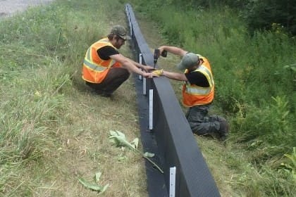 Wes and Dean installing permanent Animex fencing on Hwy 7 near Madoc, Ontario