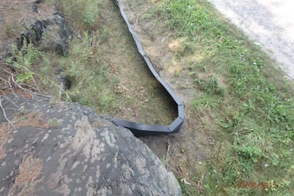 Fence end ties into a Canadian Shield rock to prevent breaches