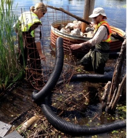 Installing pond leveler pipe at drainage culvert to ensure water flow